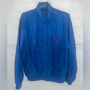 Blue windbreaker, vintage with a thunderbird embroidered on the chest